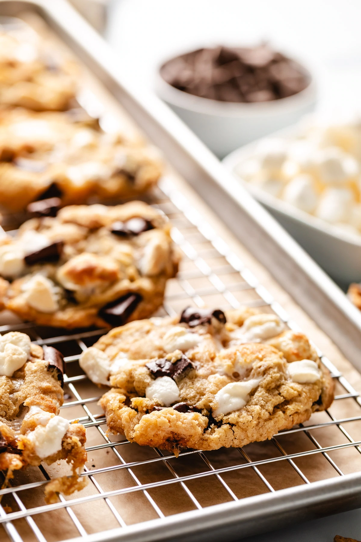 Batch of cookies next to marshmallows.