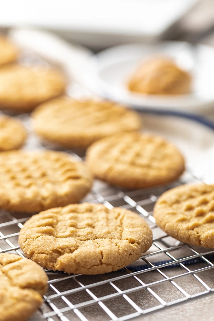Peanut butter cookies cooling on a rack.