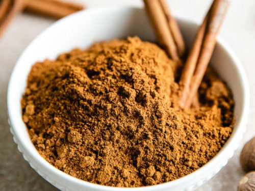Close up of a white bowl holding pumpkin pie spice.