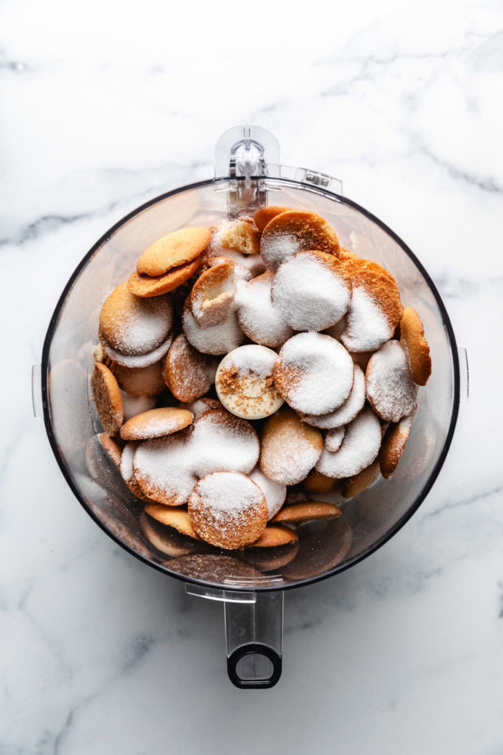 Vanilla wafers and sugar in a food processor.