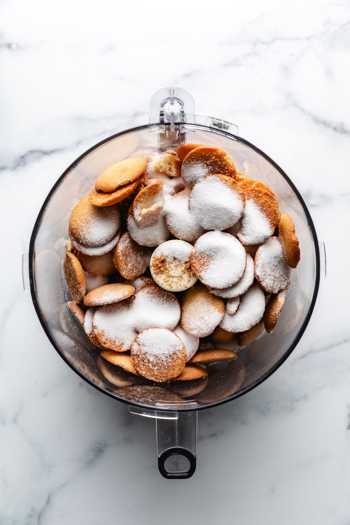 Vanilla wafers and sugar in a food processor.