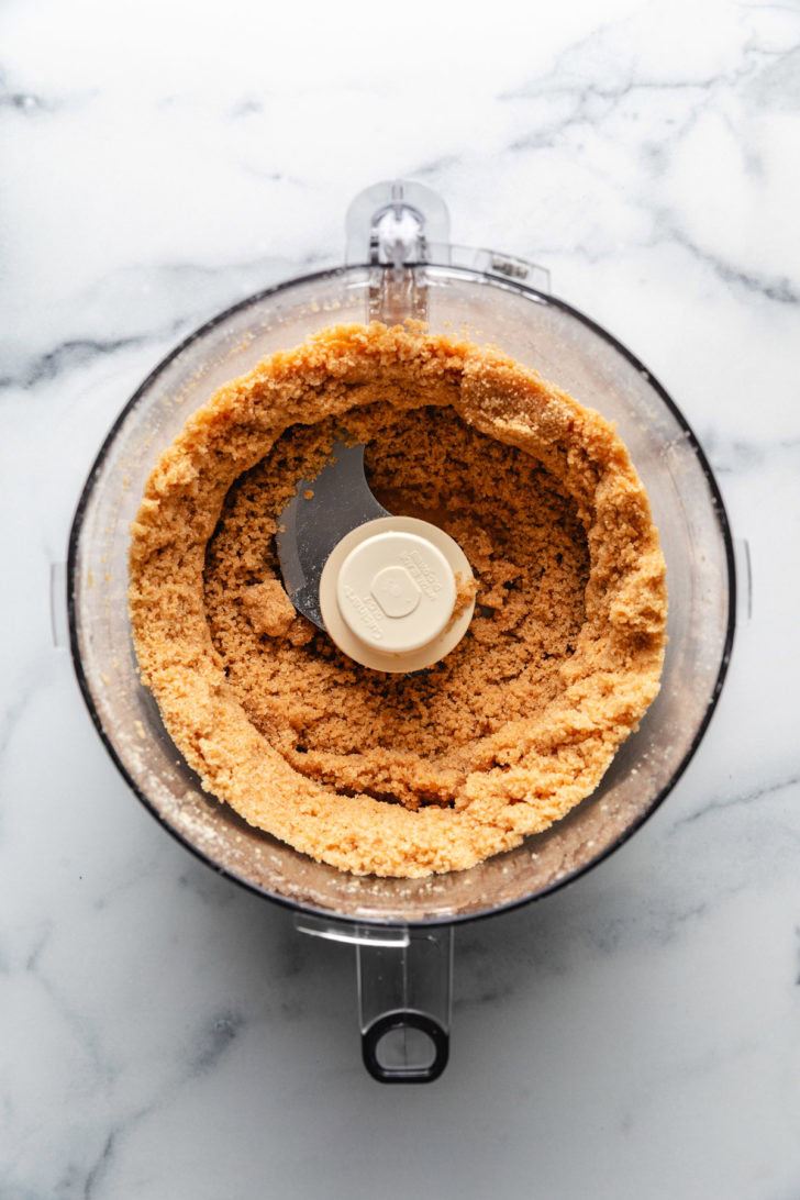 Cookies, sugar, and butter mixed in a food processor.