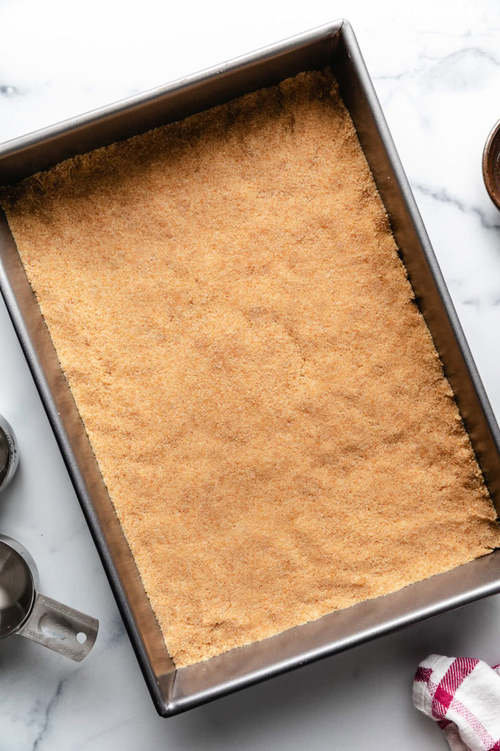 Vanila wafer crust in a metal pan.