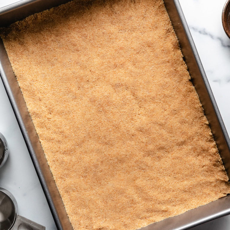 Vanilla wafer crust in a rectangular pan.