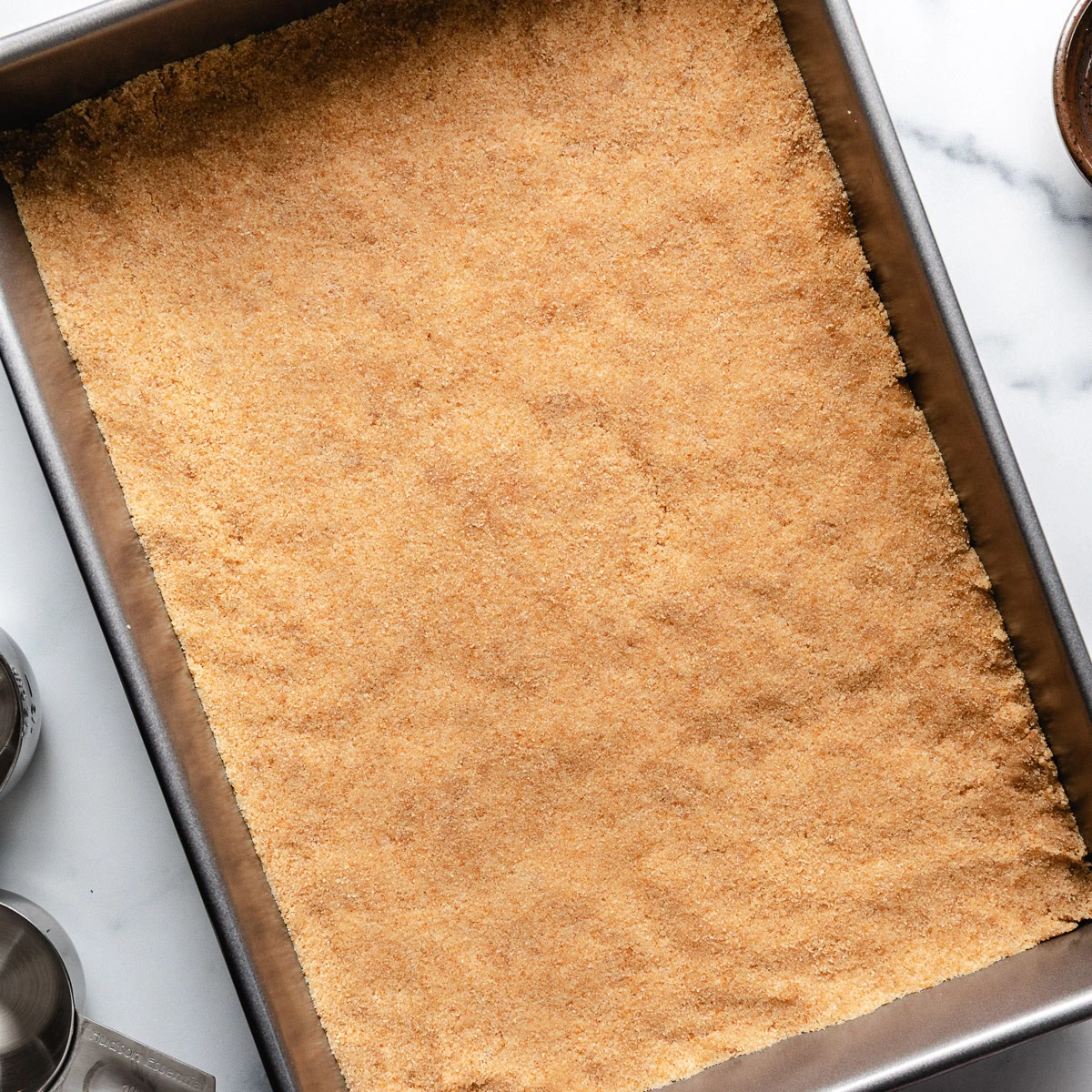 Vanilla wafer crust in a rectangular pan.