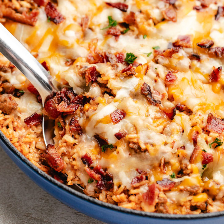 Spoon scooping bacon cheeseburger skillet casserole.