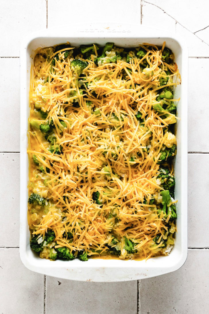 Shredded cheese spread over broccoli casserole.