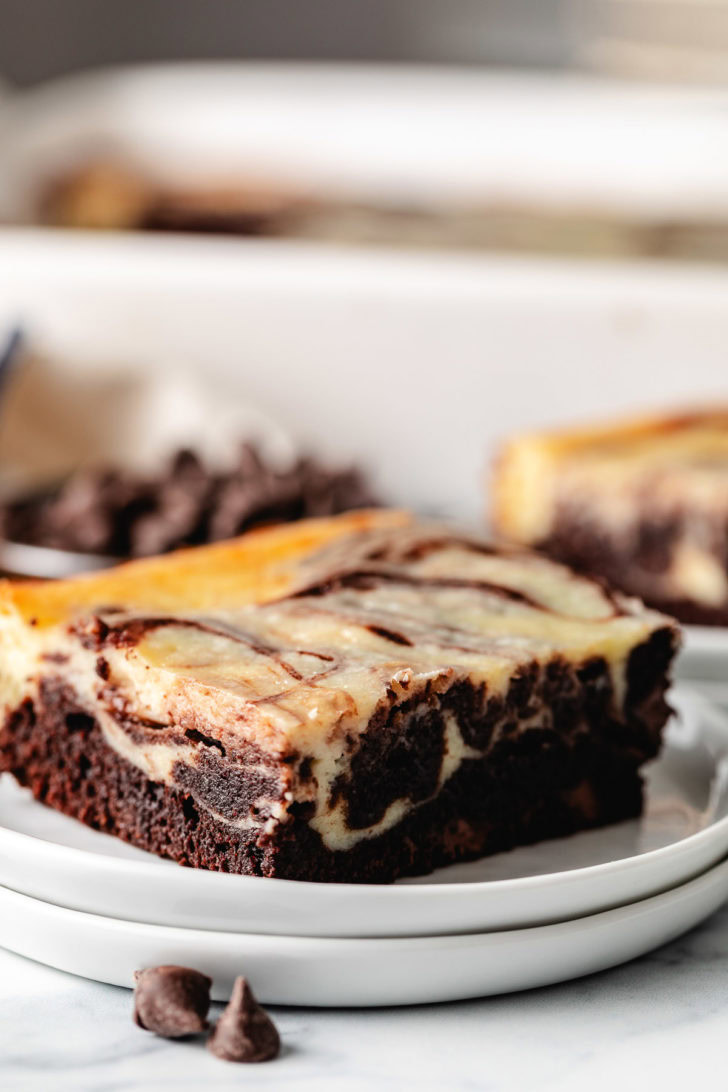 Fudgy Cheesecake Brownies Cheesecake brownie on a white plate.