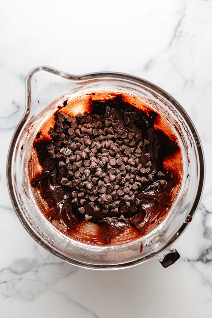 Chocolate chips in a bowl of brownie batter.