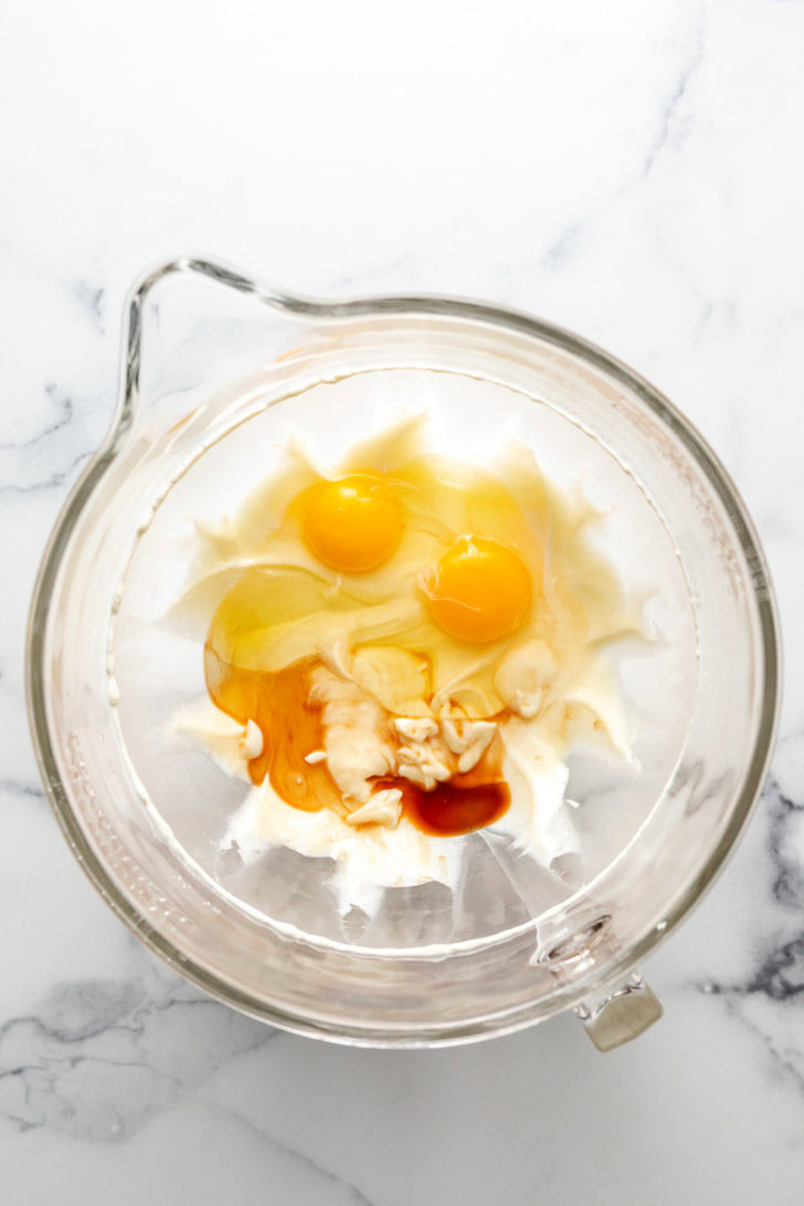 Ingredients for cheesecake batter in a bowl.
