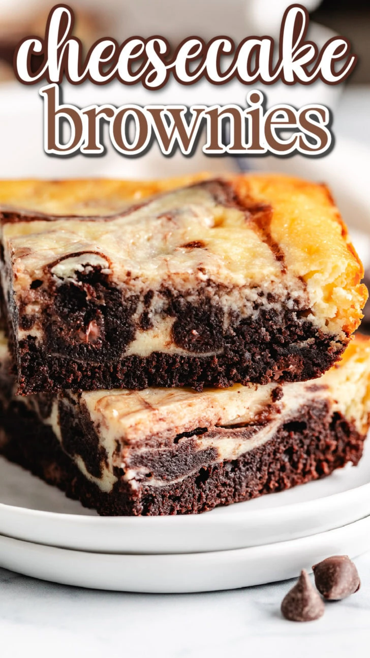 Close up view of cheesecake brownies on a stack of plates.