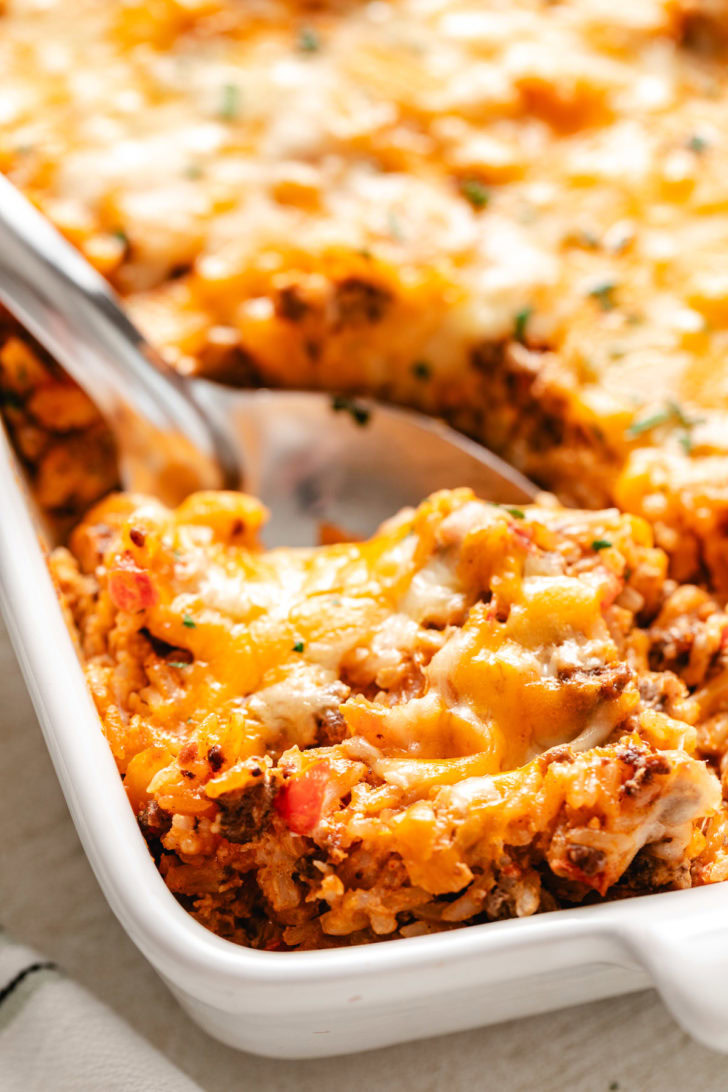 Spoon in a pan of taco rice bake.