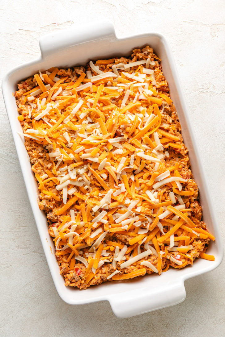 Cheese sprinkled over taco casserole.