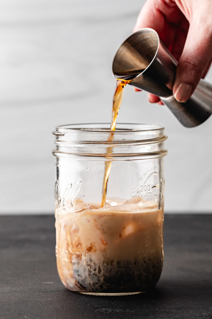 Spiced rum being poured into a jar.