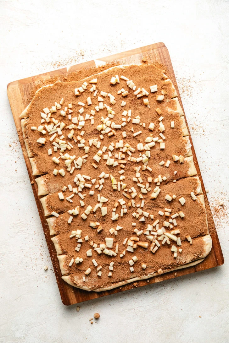 Dough with cinnamon sugar and apples.