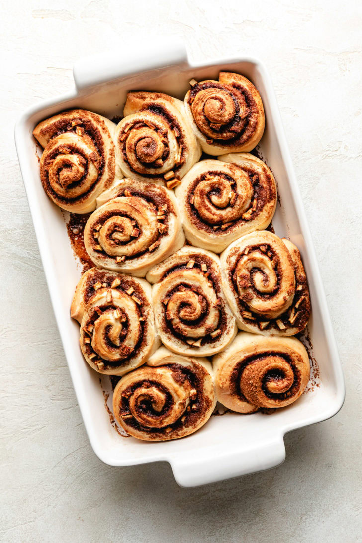 Baked cinnamon rolls in a pan.