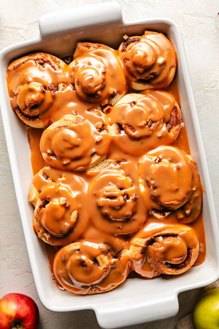Overhead view of fall flavored cinnamon rolls in a pan.