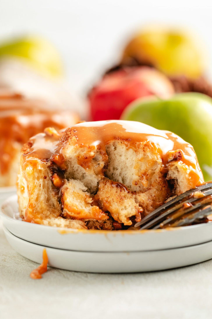 Inside view of a cinnamon roll with caramel sauce.