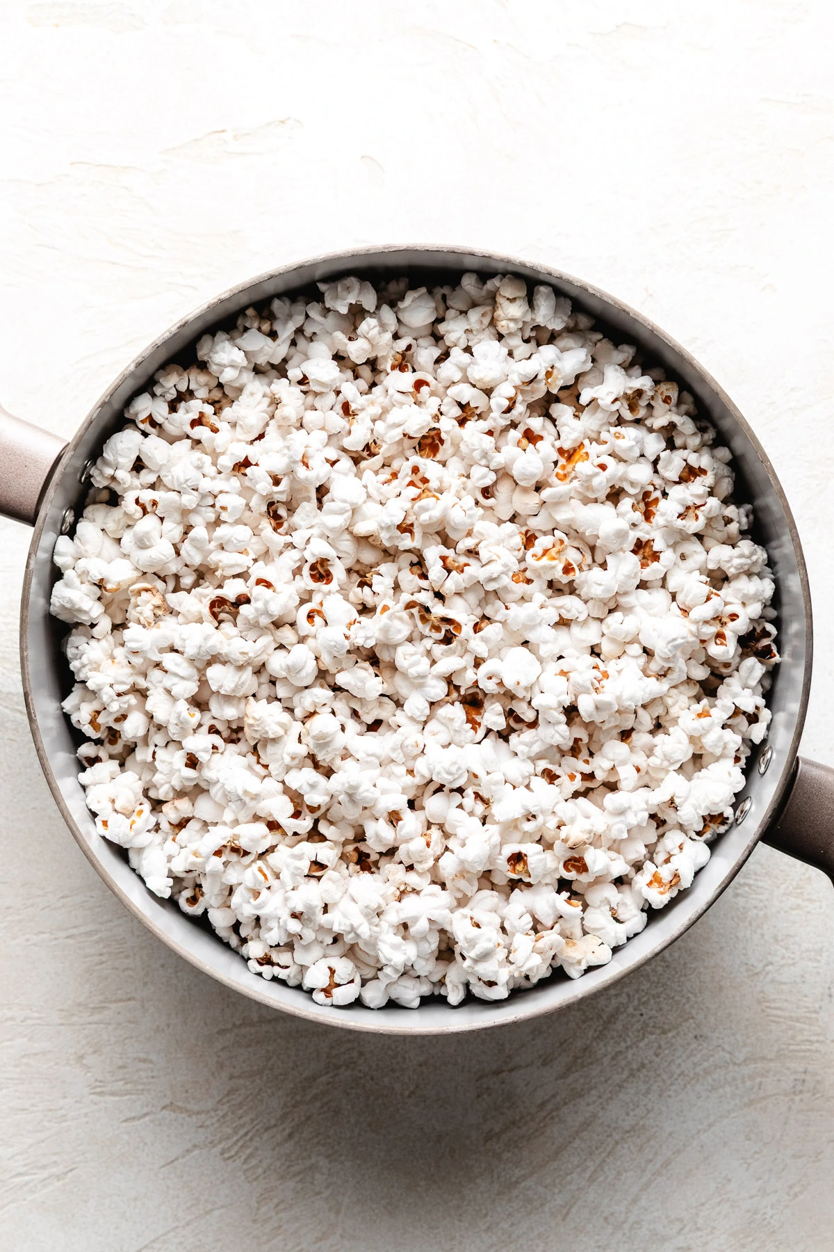 Popped popcorn in a pan.