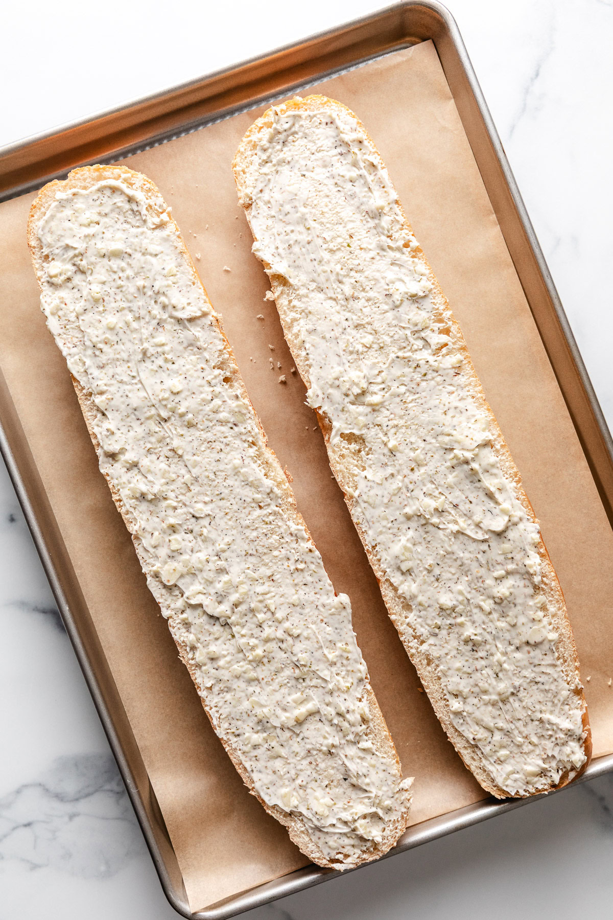 Garlic butter spread over a loaf of bread.