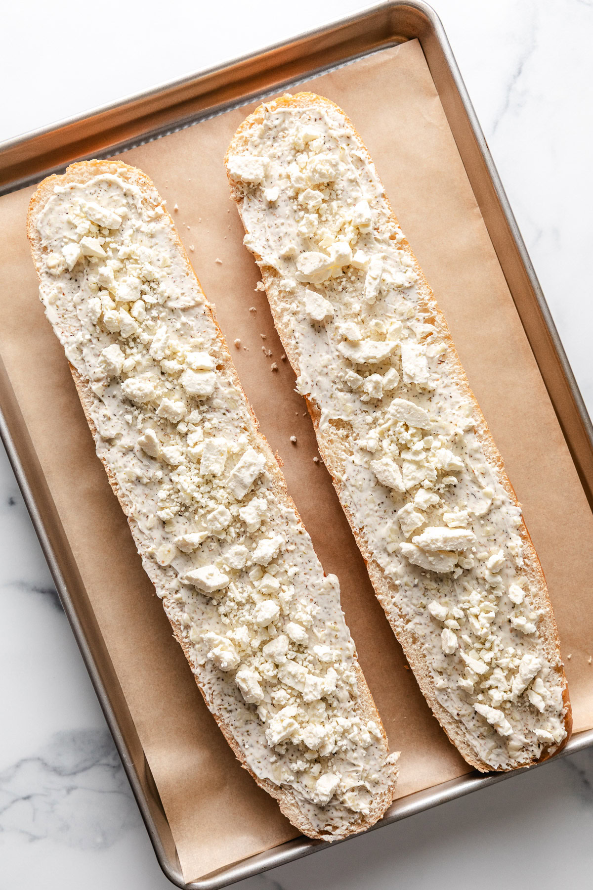 Feta sprinkled over garlic bread.