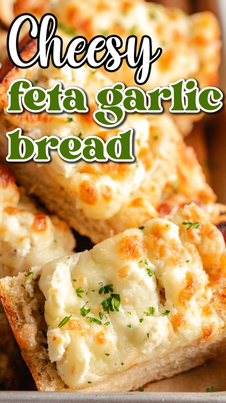 Close up view of cheesy garlic bread on a pan.