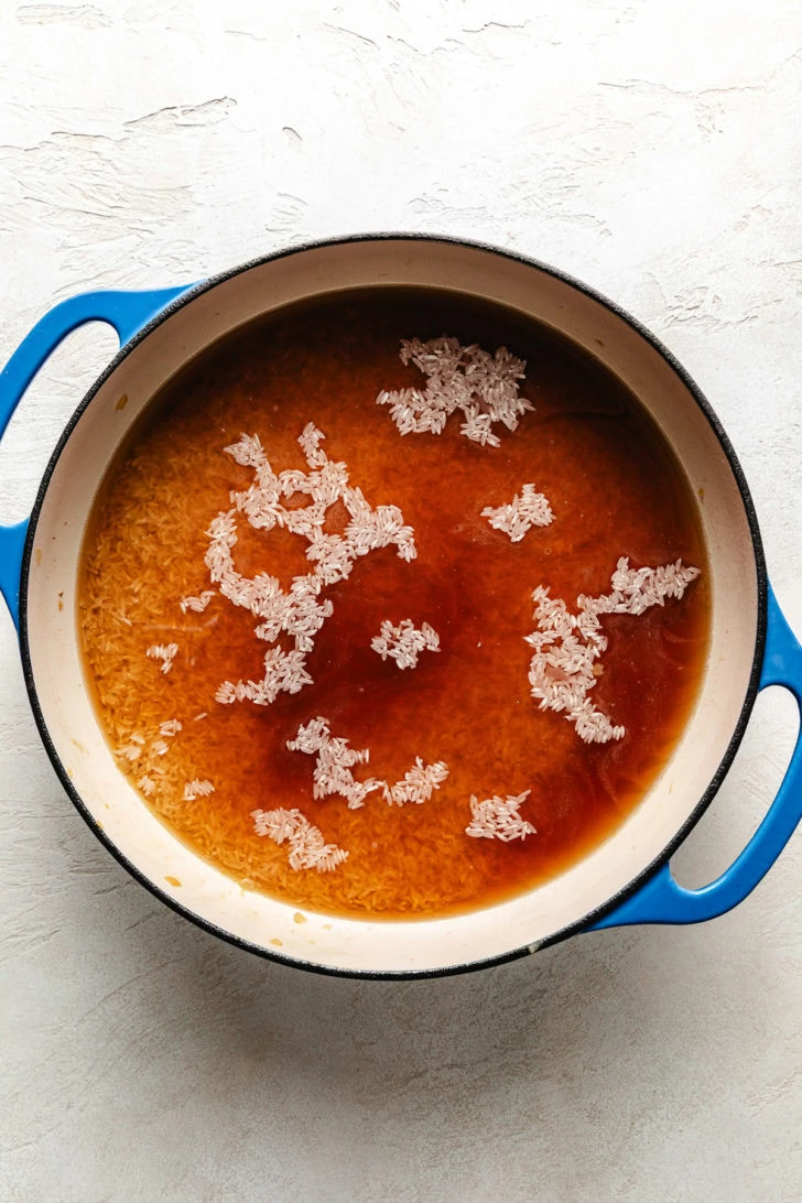 Broth and rice in a pan.