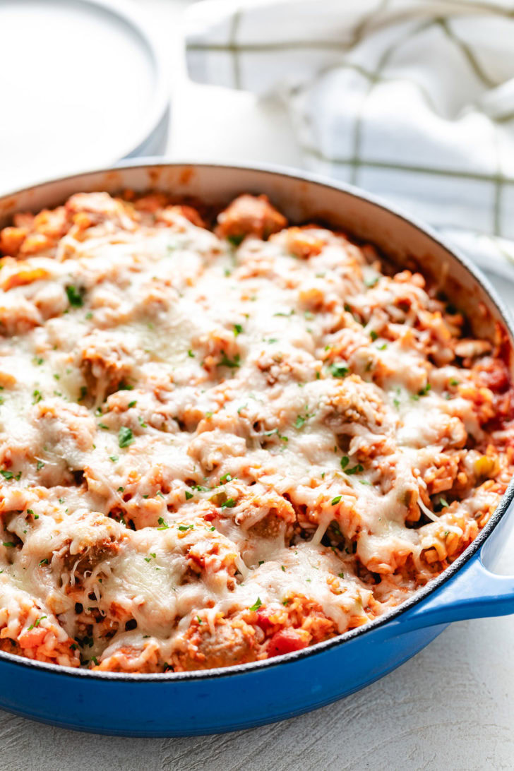One Pot Meatballs And Rice Melted cheese on a rice and meatball skillet.