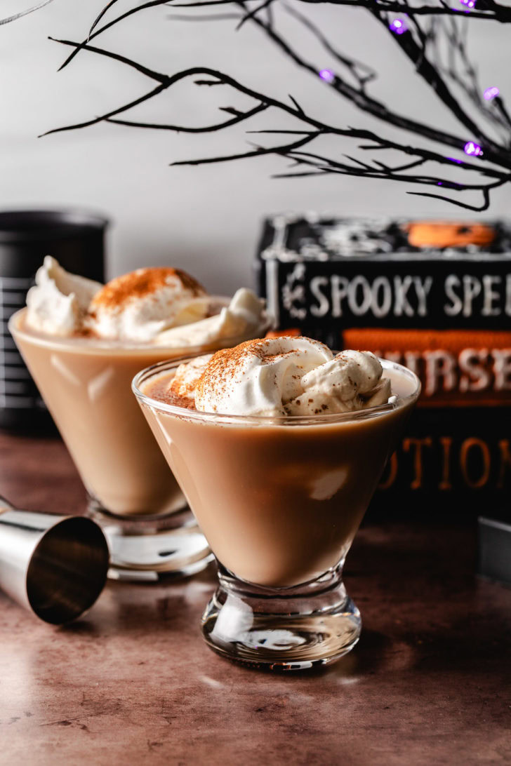 Whipped cream on two pumpkin martinis.