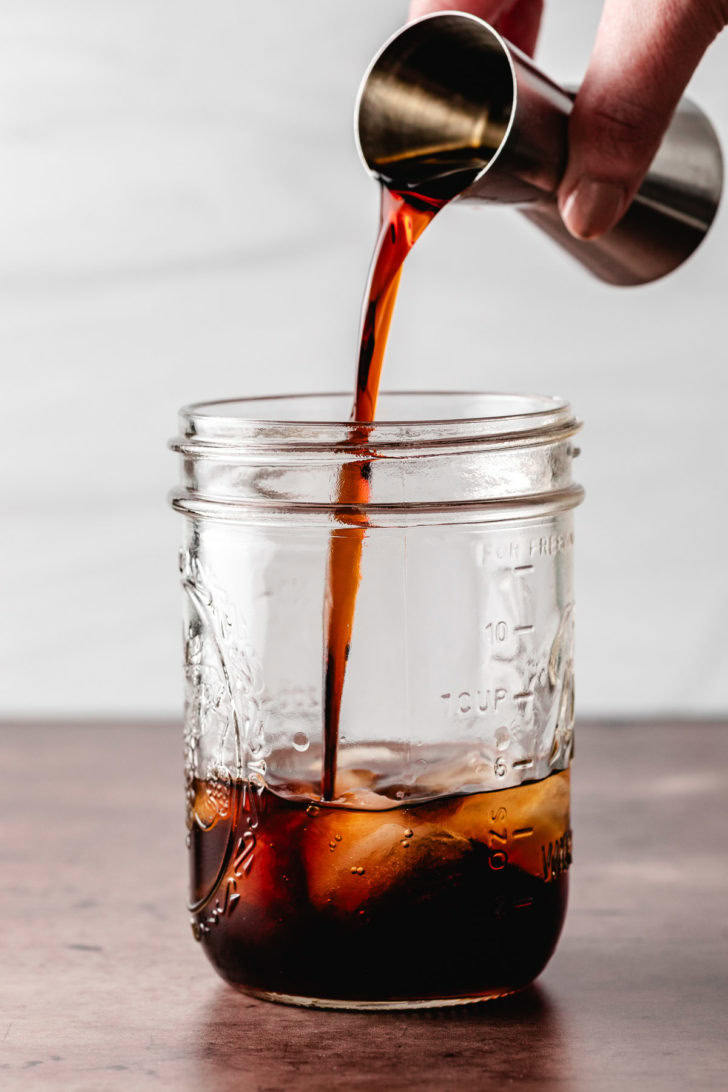 Coffee liqueur being poured into a jar.