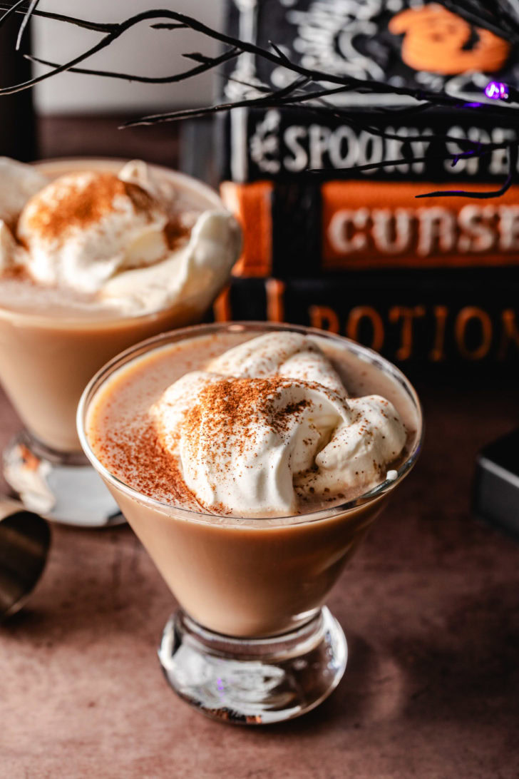 Whipped cream and cinnamon on two martinis.