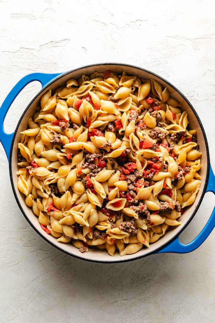 Beef, rotel, and pasta in a pan.