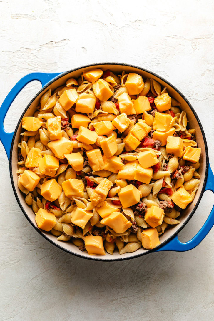 Velveeta cubes added to pasta.