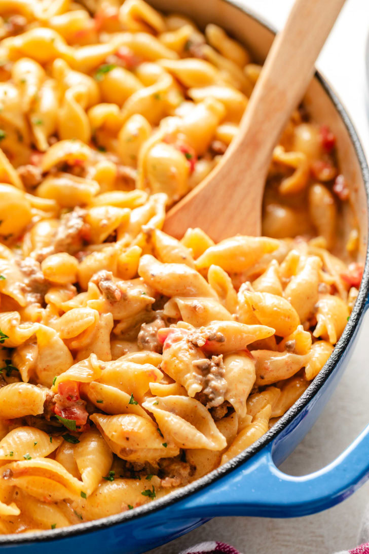 Large pan filled with creamy shells pasta.