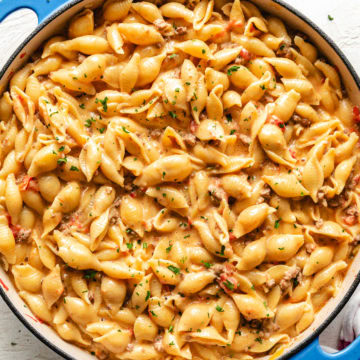 Close up view of cheesy rotel pasta in a blue pan.