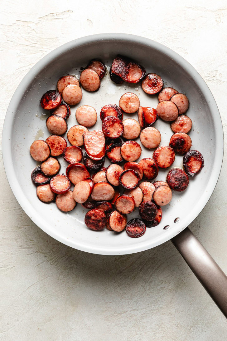 Cooked sausage in a skillet.