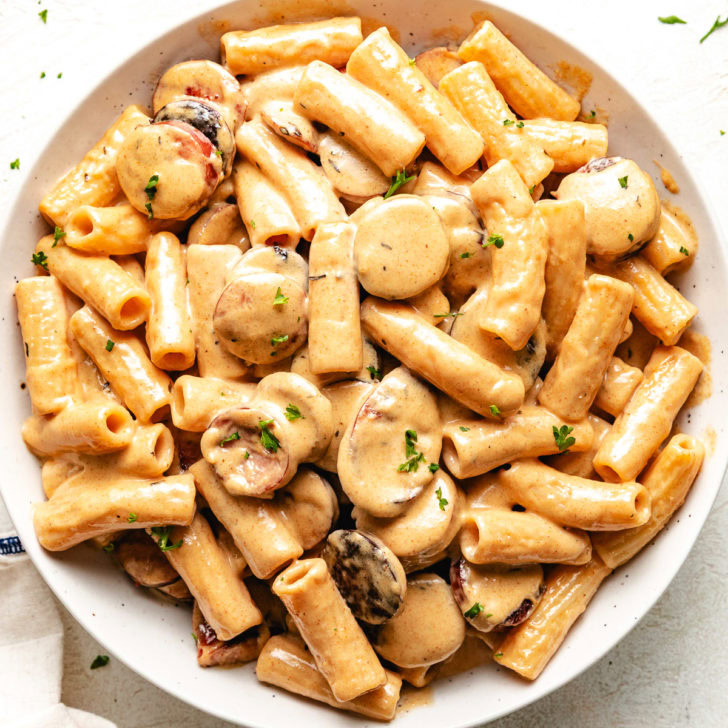 Close up view of bowl of cajun sausage pasta.