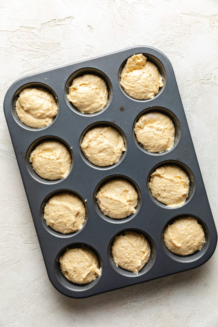 Moist Cornbread Muffins Cornbread batter in a muffin pan.