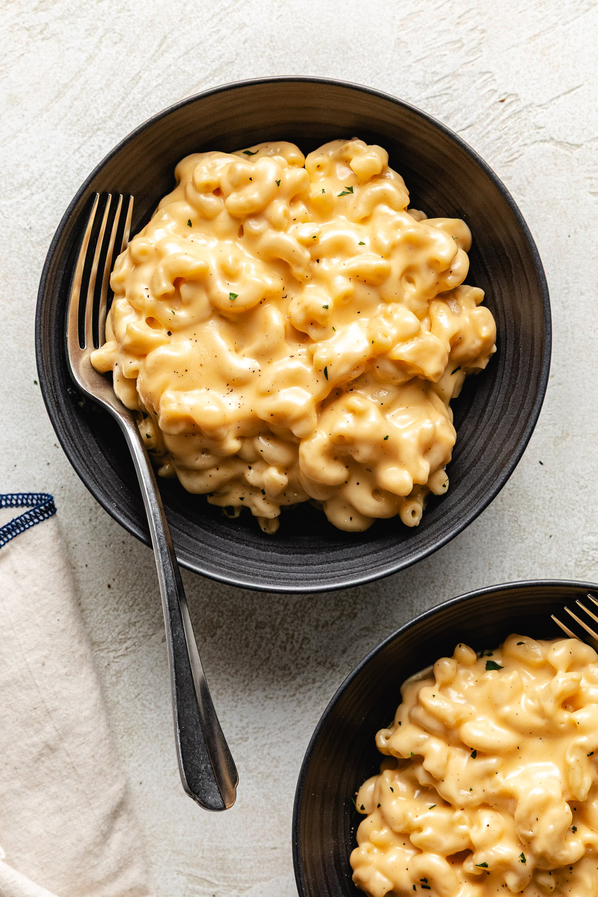 Fork in a bowl of macaroni and cheese.