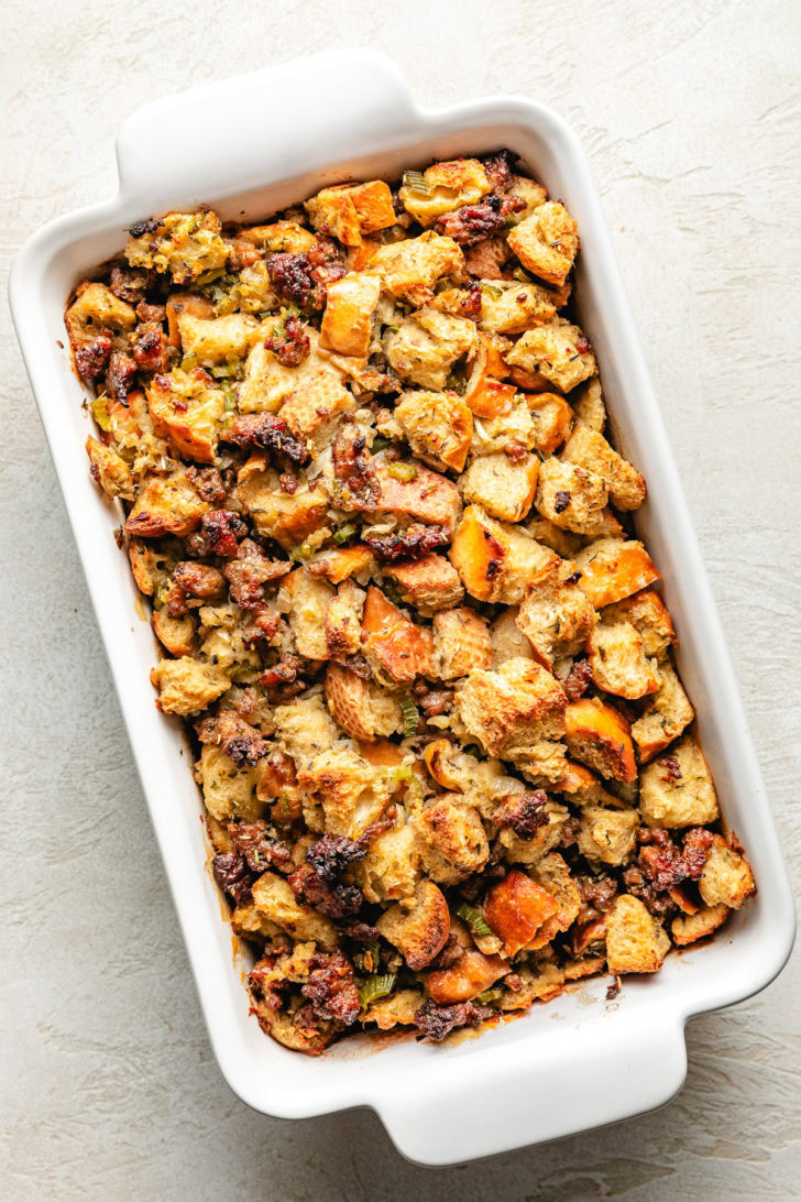 Classic Sausage Stuffing Baked sausage stuffing in a white dish.