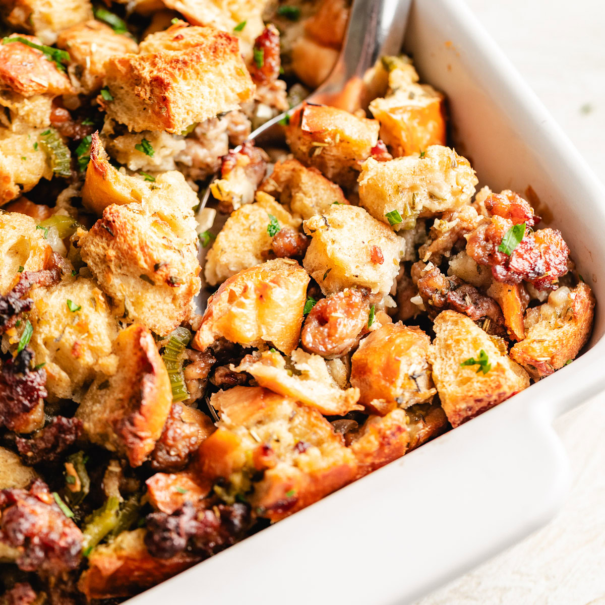 Close up view of golden brown sausage stuffing.