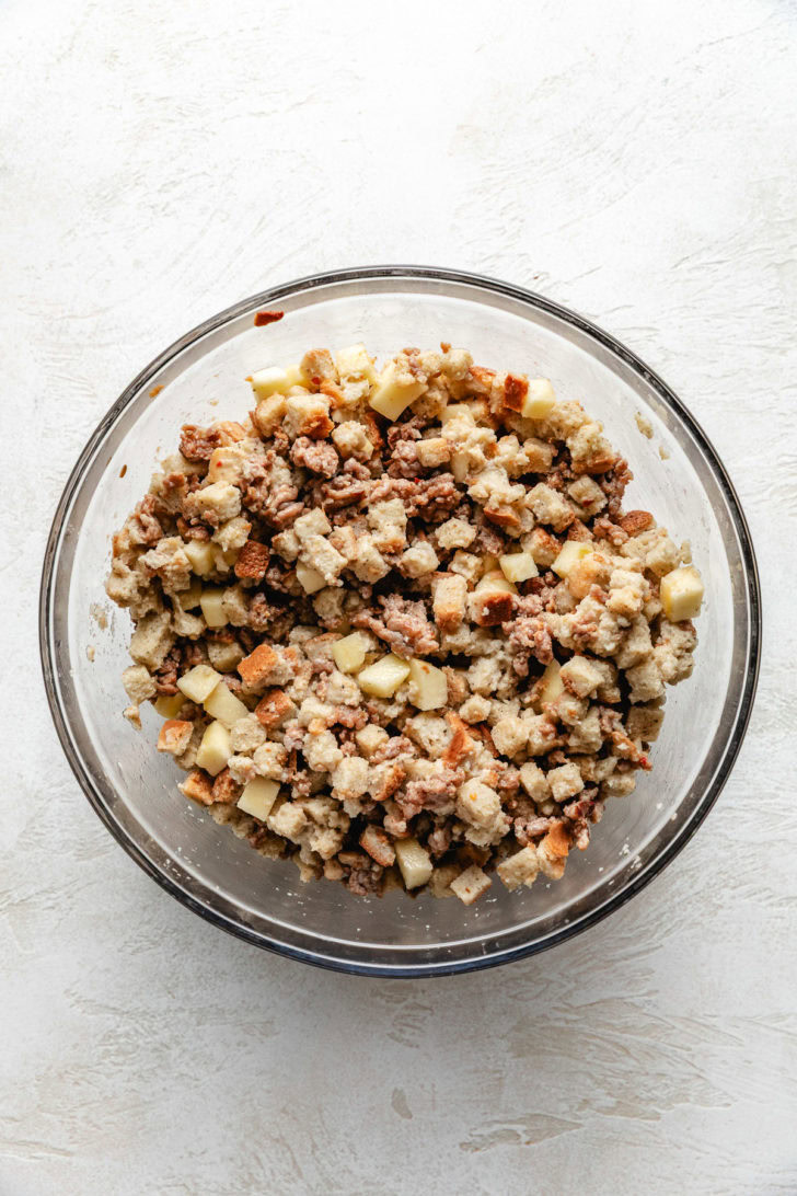 Stuffing Muffins Mixing bowl filled with stuffing mix and apples.