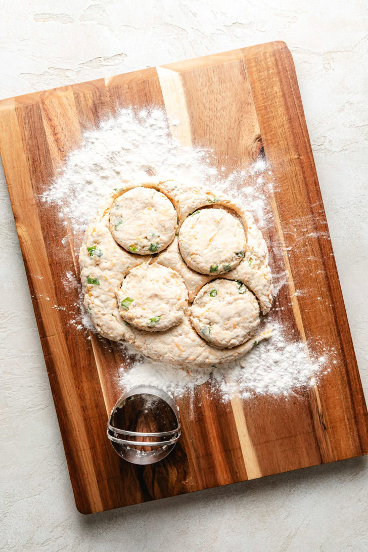 Easy Cheddar Scallion Biscuits Biscuit dough on a cutting board.