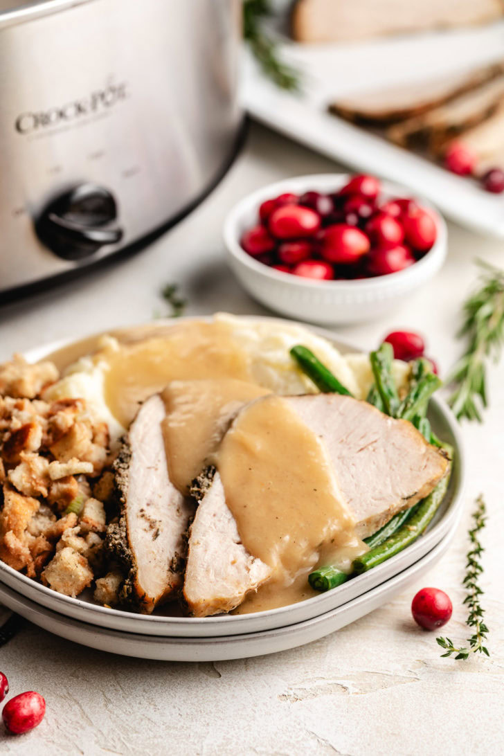 Slices of turkey, mashed potatoes, and green beans.