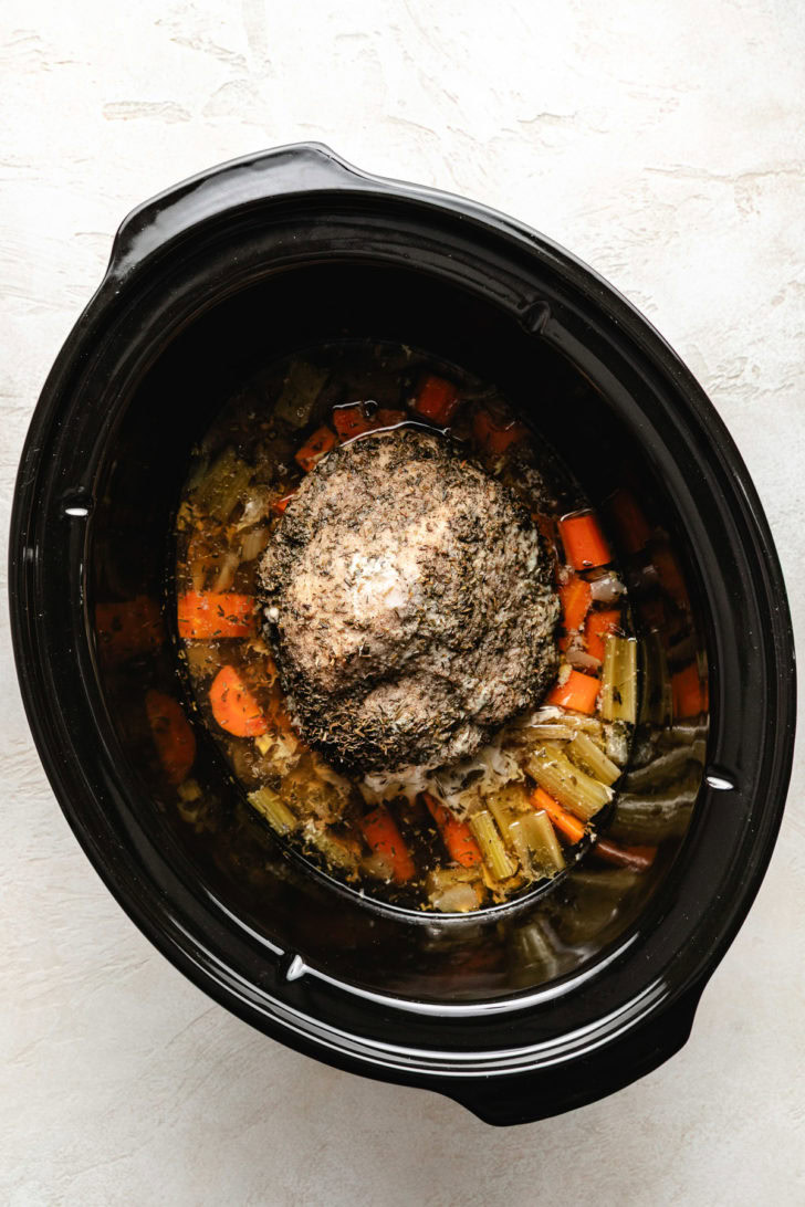 Cooked turkey breast in a slow cooker.