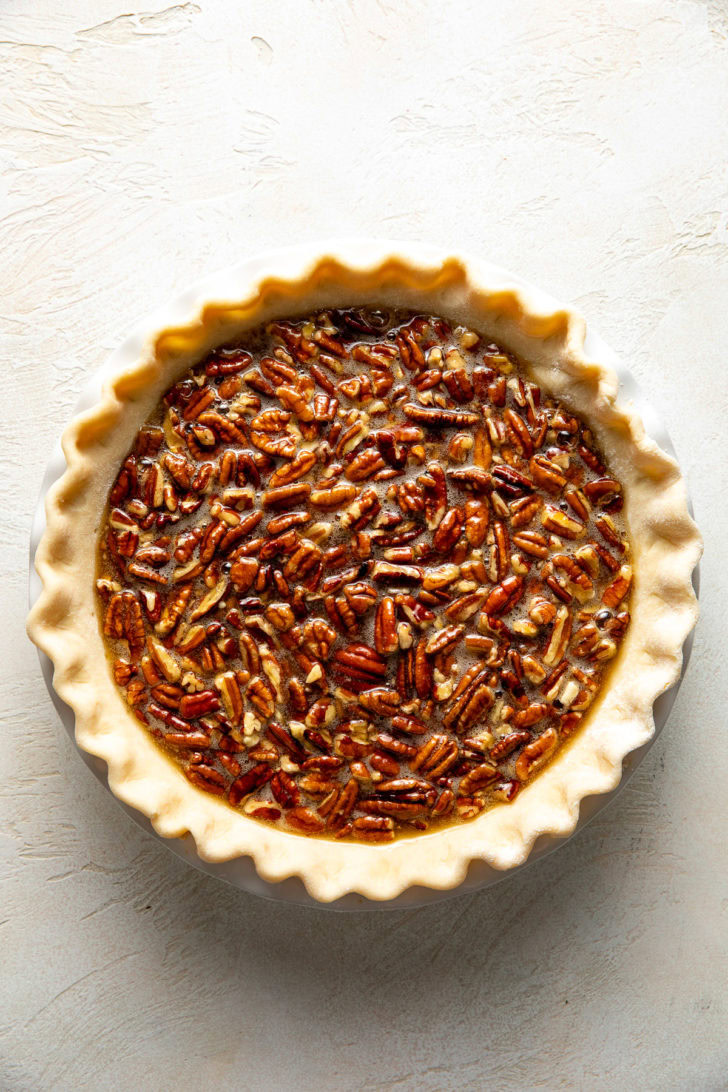 Pecan pie filling in an unbaked pie shell.