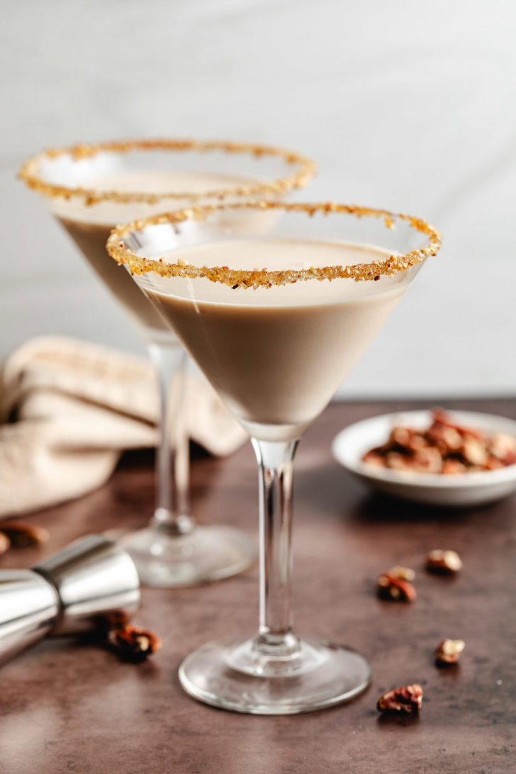Pecan pie martini next to a bowl of pecans.