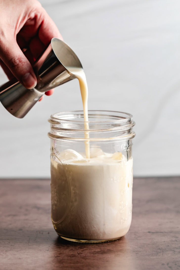 Butter pecan liqueur poured into a mason jar.