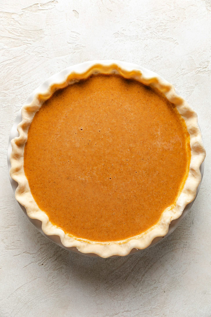 Perfect Pumpkin Pie Unbaked pie filling in a pie shell.