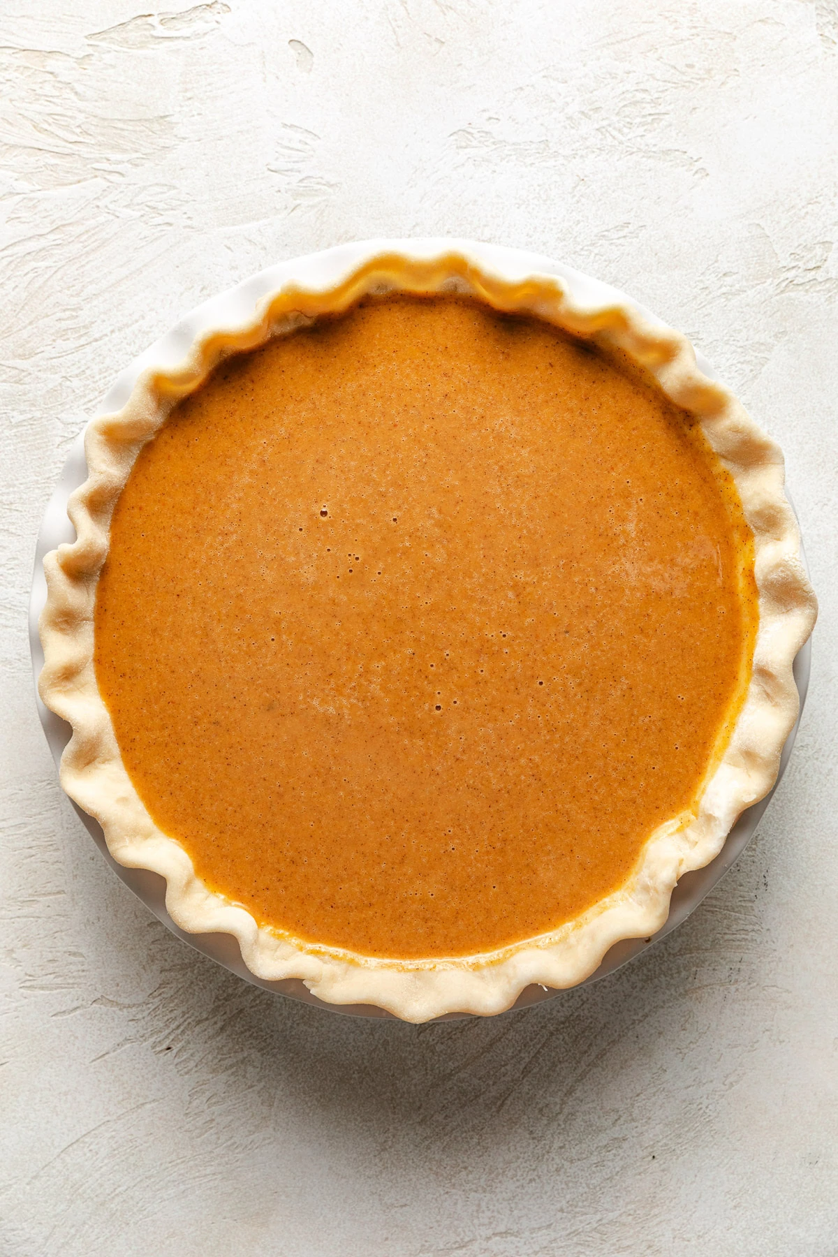 Unbaked pie filling in a pie shell.